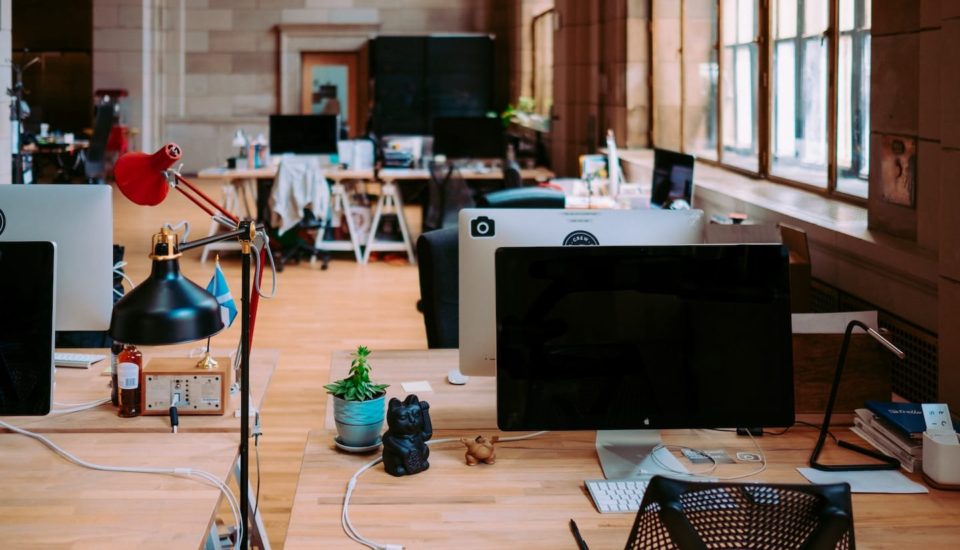 A room with many computers on the tables