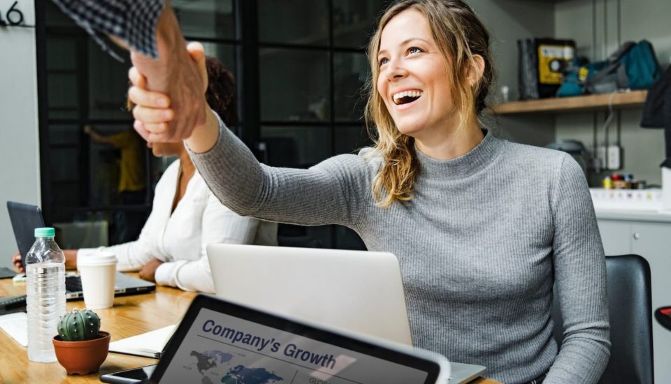 A woman giving a high five to another person.