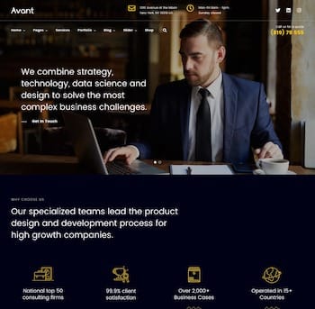 A man sitting at a table with a laptop.